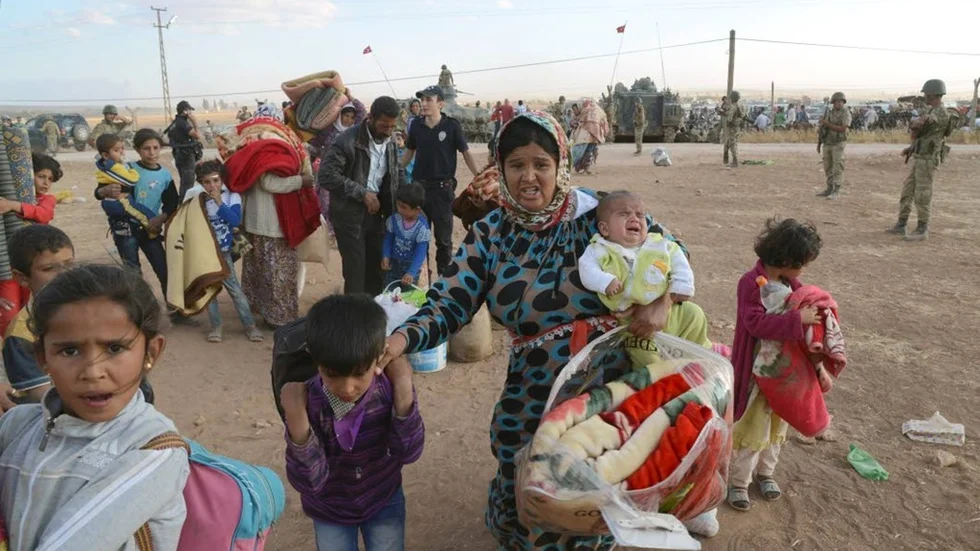 Syriska flyktingar vid gränsövergången Suruc,Turkiet, på flykt undan den terror som IS utsätter de för.