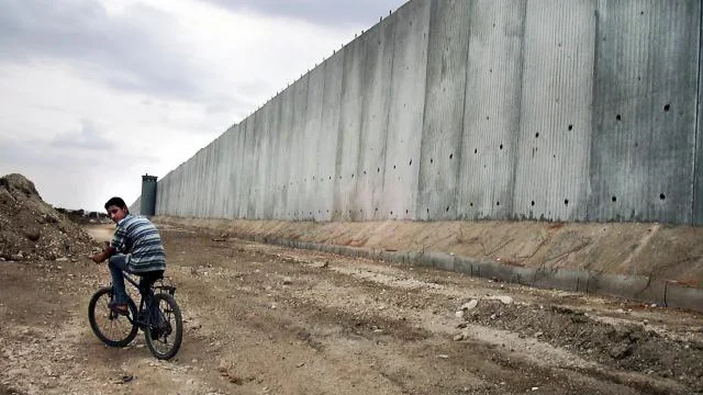 En israelisk soldat patrullerar nära "Muren" eller "säkerthetsbarriären i den palestinska staden Qalqilya. BILD: PRESSENS BILD