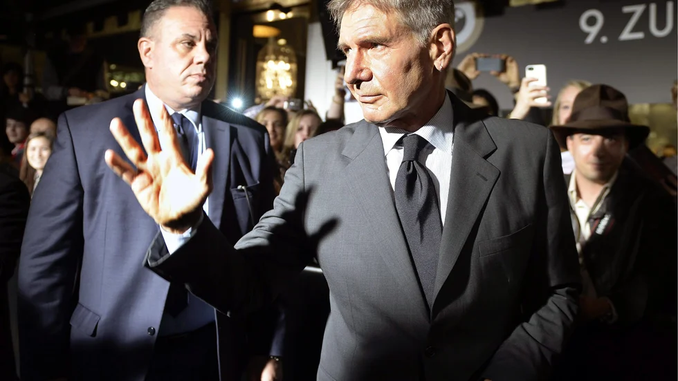 American film actor and producer Harrison Ford arrives to receive the Lifetime Achievement Award at the 9th annual Zurich Film Festival in Zurich, Switzerland, Friday, Oct. 4, 2013. Some people in the crowd seem to be wearing fedora hats of the type made famous by Ford's Indiana Jones character in his Raiders of the Lost Ark movies. (AP Photo / KEYSTONE, Walter Bieri)