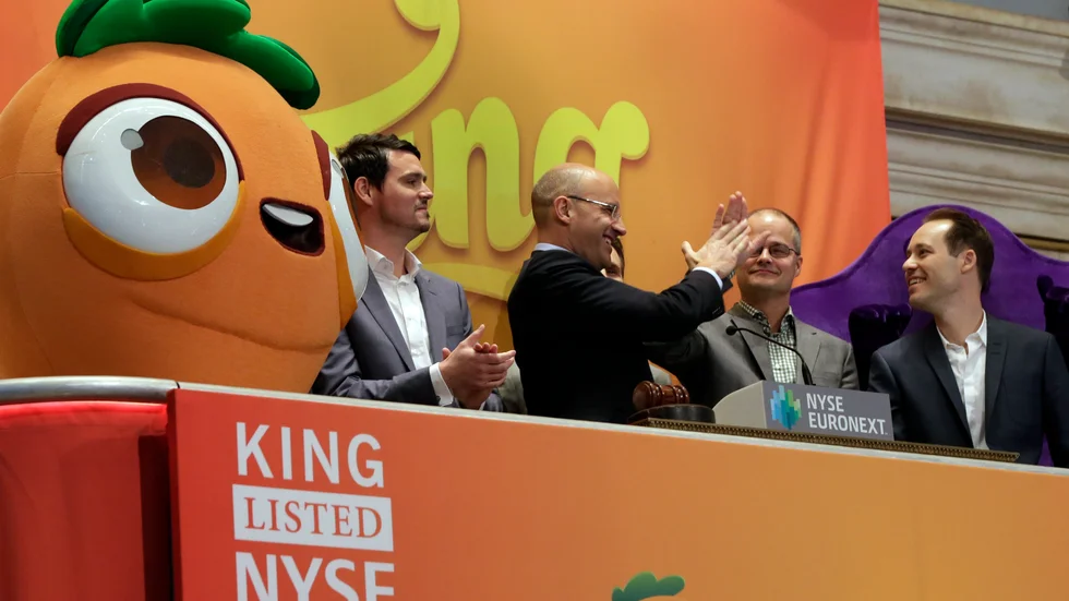 King Digital Entertainment CEO and founder Riccardo Zacconio second left, high-fives with company co-founder Lars markgren, the maker of Candy Crush Saga and Farm Heroes Saga, during opening bell ceremonies at the New York Stock Exchange, before King Digital's IPO, Wednesday, March 26, 2014. The stock market opened higher Wednesday after a strong report on American manufacturing. The maker of the hit game "Candy Crush Saga" flopped in its market debut.(AP Photo/Richard Drew)