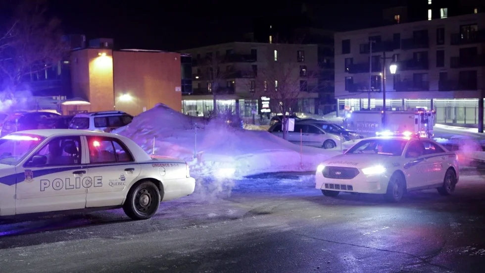 Police survey the scene after deadly shooting at a mosque in Quebec City, Canada, Sunday, Jan. 29, 2017. Quebec Premier Philippe Couillard termed the act "barbaric violence" and expressed solidarity with victims' families. (Francis Vachon/The Canadian Press via AP)