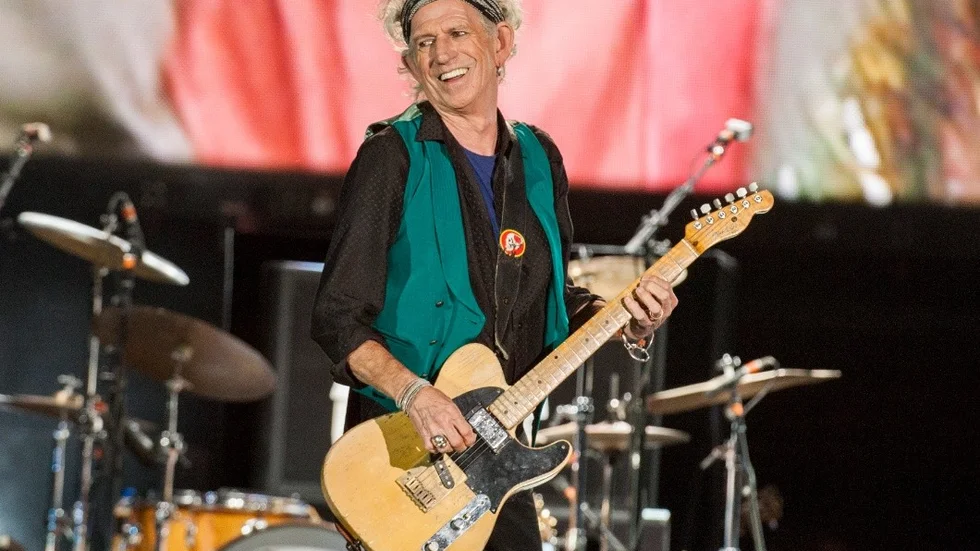FILE - In this July 15, 2015, file photo, Keith Richards of the Rolling Stones performs at Le Festival d'ete de Quebec in Quebec City.Richards has saluted vocalist Merry Clayton of Gimme Shelter fame and an all-star gathering of jazz musicians has paid tribute to saxophonist Sonny Rollins on the Apollo Theaters stage. It was a showcase for friends stepping up on behalf of honored and absent guests. (Photo by Barry Brecheisen/Invision/AP, File)