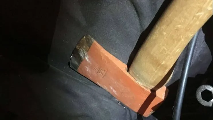 Färg från dörren. I mannens bostad fann polisen en yxa med färska färgavskrap. Enligt kvinnan ska mannen slagit sönder en ruta i hennes ytterdörr med yxa.