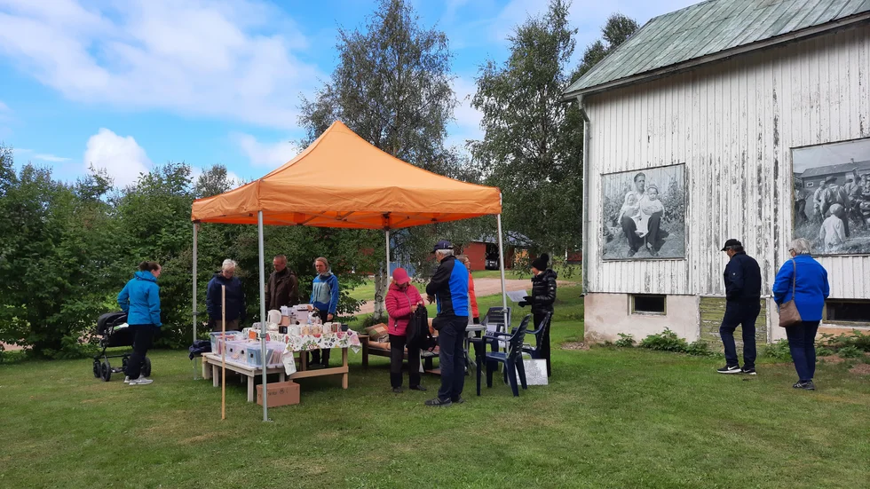 En av försäljningsställena under byaloppisen i Kaunisvaara var utanför John Sandfeldts f d affär. De stora bilderna i de gamla skyltönstrena är tagna på 1950-talet av byns egen fotograf Brynolf Lantto.