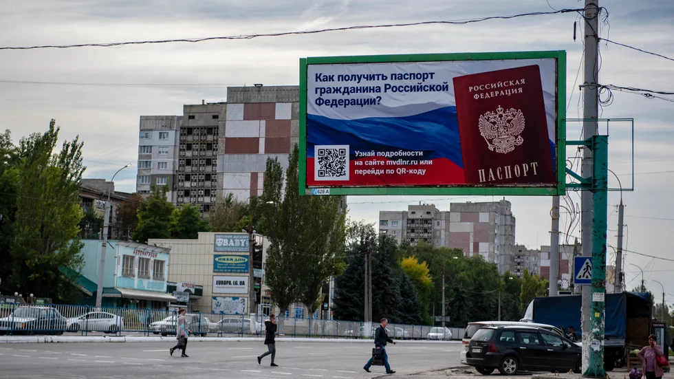 "Hur skaffar man ett rysk pass?" Reklamskylt i Luhansk inför de så kallade folkomröstningar om att bli en del av Ryssland som anordnades i flera ockuperade delar av Ukraina i fjol. Arkivbild.