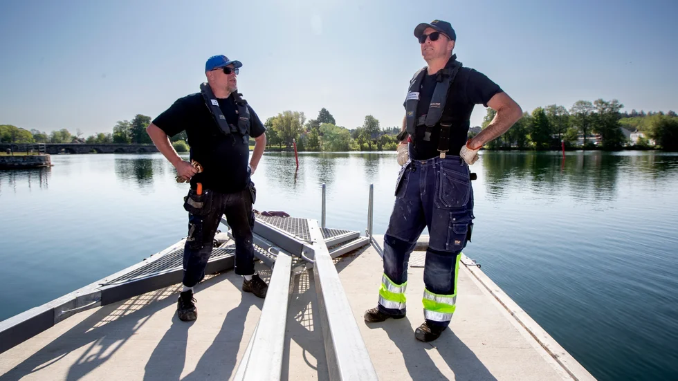 Göta Kanals Robin Andersson och Joakim Fornander klagade inte på vädret när de jobbade med att förankra de yttre flytbryggorna i Motala hamn. 