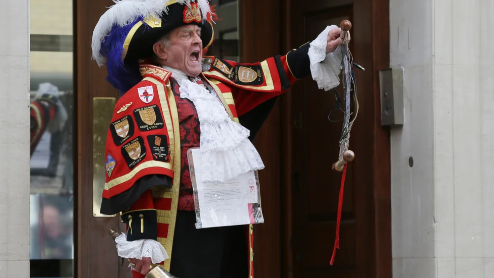 Tony Appleton, a town crier, announces to the assembled media the birth of the royal baby, outside the Lindo Wing, St. Mary's Hospital, London, Saturday, May 2, 2015. Kate, the Duchess of Cambridge, has given birth to a baby girl, royal officials said Saturday.  (AP Photo/Tim Ireland)