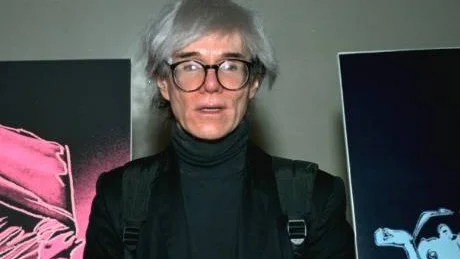 **FILE**Pop artist Andy Warhol is shown in this 1987 file photo. One of his signature silver wigs brought $10,800 when put up on the block at Christies Auction House in New York, Thursday, June 22, 2006. The hairpiece was part of an auction of celebrity memorabilia. (AP Photo/File)