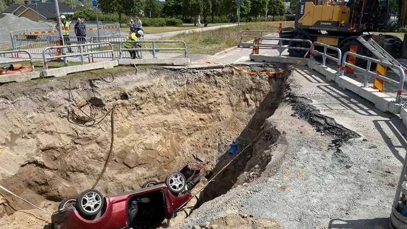 Av oklar anledning har bilen åkt ner i grävhålet. 