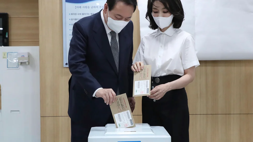 Sydkoreas president Yoon Suk-Yeol och hans fru Kim Keon-Hee lägger sina röster i en vallokal i Seoul i fredags. Arkivbild.