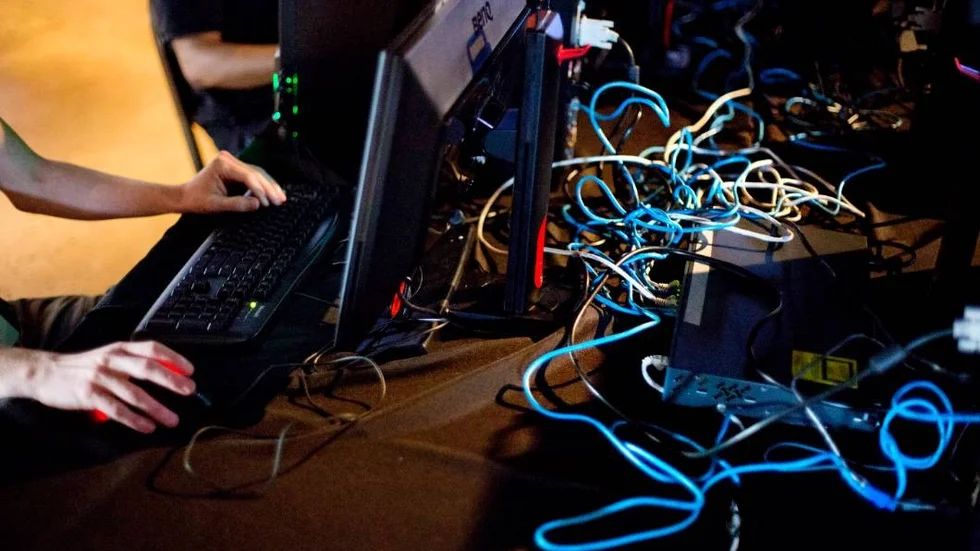 In this July 11, 2014 photo, cables connect computers as gamers compete against each other in the Red Bull Battle Grounds "StarCraft II" video game tournament in Atlanta. Professional gamers and amateurs from the U.S., Canada, China, South Korea and Australia competed in the three day tournament of the science-fiction strategy video game "StarCraft II." The contestants wear special noise-canceling headphones while spectators cheer in a live arena as announcers provide the play-by-play. Choi "Bomber" Ji Sung, of South Korea, won the the 128 player bracket and the $8,000 prize purse advancing to the Battle Grounds Grand Final which takes place September 20th21st in Washington. (AP Photo/David Goldman)