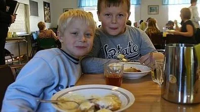 Sjuåriga Filip Levin, till vänster, tycker att äppelfesten är jätterolig och det bästa är den goda vaniljsåsen. Med på bilden är också Jesper Eriksson, 7 år.