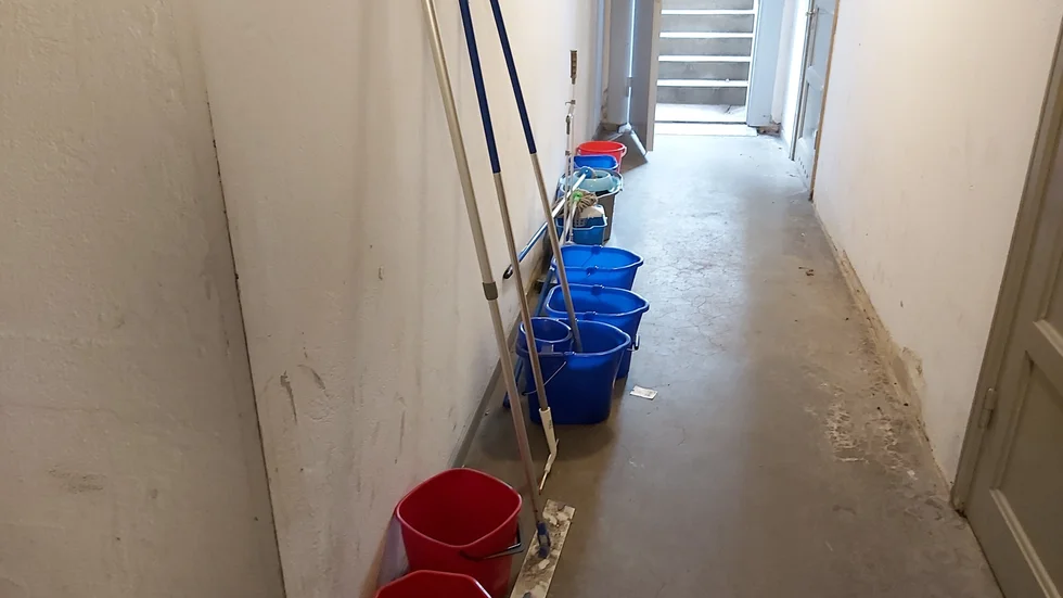 Hinkar och trasor på rad för att rädda källaren i lägenhetshuset i centrala Norrköping.