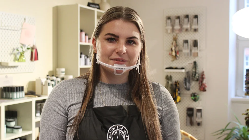 Frisören Rebecca Johnsson tycker att det går bra att jobba med munvisir. "Det är lite trevligare när man kan se munnen", säger hon.