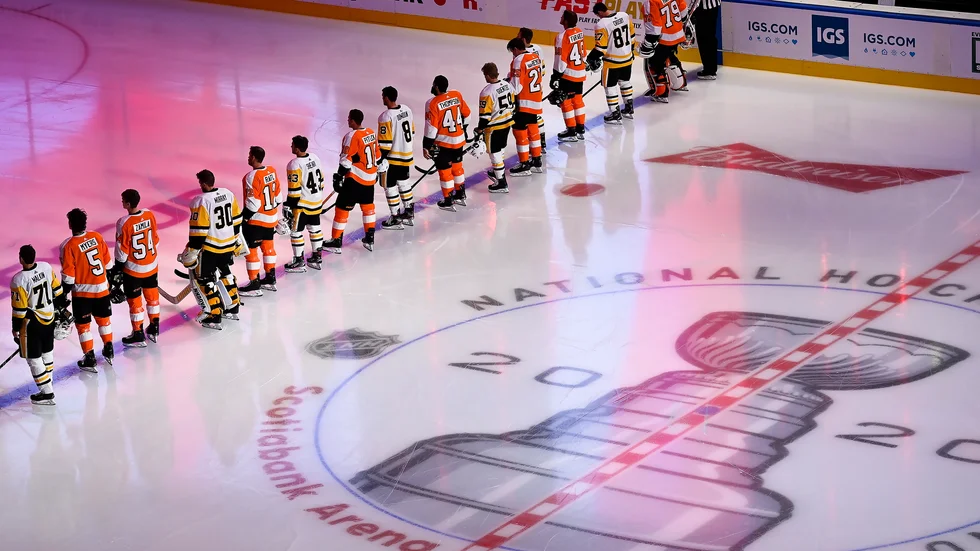 Spelarna i Pittsburgh och Philadelphia ställer gemensamt upp på isen inför lagens träningsmatch i Toronto.
