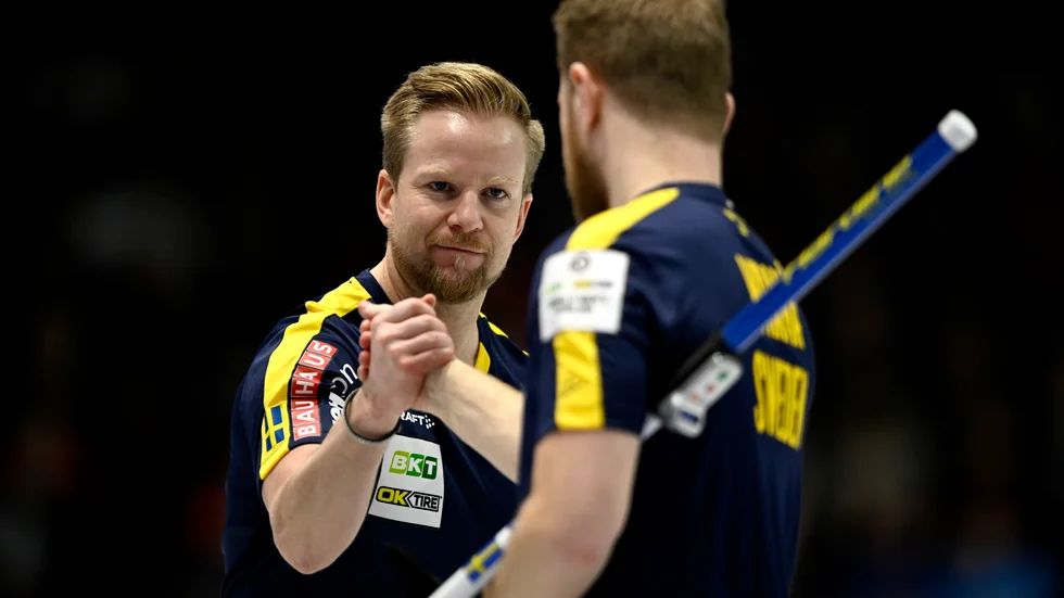 Svenske skippern Niklas Edin firar med lagkamraten Rasmus Wrana efter vinsten mot Nya Zeeland.