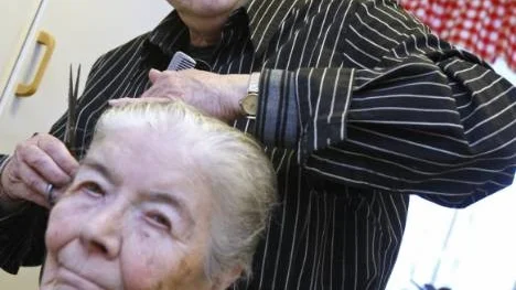 Laila Andersson blir klippt hemma i sitt kök av Isa Broström, som satsar på en framtid som ambulerande frisör.