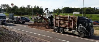Släp med timmer har vält i rondell
