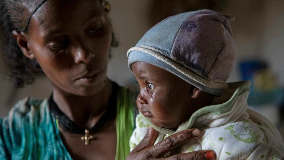 Adaba tröstar sitt barn i Tigray. Trots larmen kommer inte förnödenheter fram.