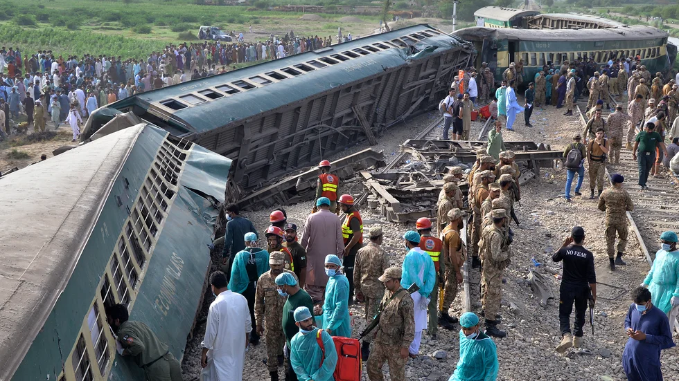 Räddningstjänst och militär på olycksplatsen, nära en järnvägsstation i staden Nawabshah i Sindh-provinsen.