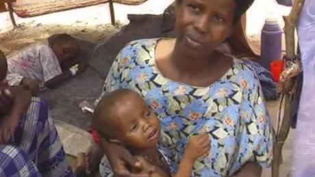 Somali woman Kaltum Mohamed holds one of her children in Lower Shabelle Somalia  on July 20, 2011 in this image  taken from TV. Kaltum Mohamed has lost 4 of her children to famine. Just three weeks ago, she was the mother of five young children. But famine has come to Somalia and claimed the lives of four of them. Only a daughter remains now. (AP Photo/APTN)