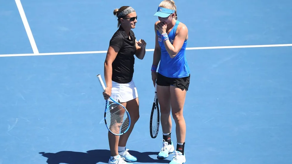Belgium's Kristen Flipkens, left, and Sweden's Johanna Larsson chat during the doubles semifinals of the ASB Classic women's tennis tournament in Auckland, New Zealand, Saturday, Jan. 5, 2019. (AP Photo/Chris Symes)