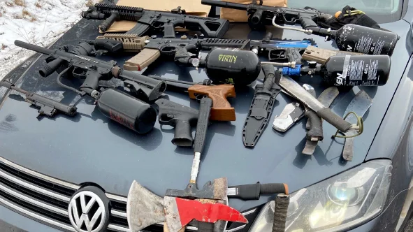 Knivar, yxor och paintball-vapen hittades när polisen stoppade en bil på E4 utanför Uppsala. Föraren åtalades men frias nu. 