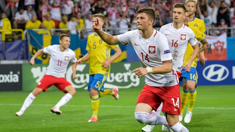 Polens Dawid Kownacki jublar efter att ha gjort 2–2 på straff under måndagens U21-match mellan Polen och Sverige (Adam Lundqvist delvis skymd med nummer fem på gul tröja).