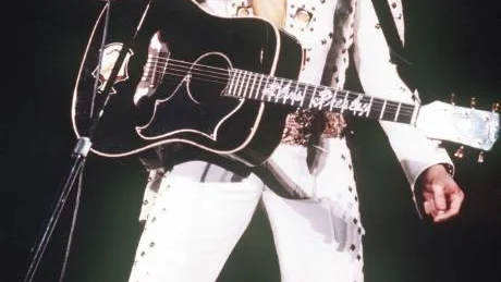 **FILE** Elvis Presley sings during a concert in this 1973 file photo. Presley fans will soon have a place in the islands to fondly remember why they couldn't help falling in love with the star of "Blue Hawaii."  Wearing his signature flare-legged, big-collared, bejeweled and strategically snug ensemble, the King will reappear in the islands in the form of a life-sized bronze statue marking the site of his historic 1973 concert "Elvis: Aloha From Hawaii." (AP Photo)