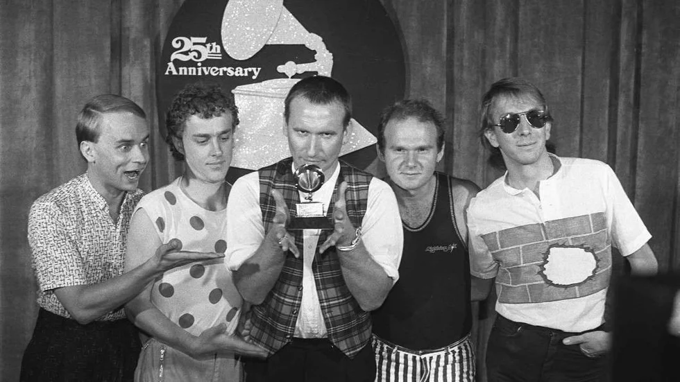 FILE - Members of "Men at Work" pose with their Grammy for best new artist at the awards show in Los Angeles in this Feb. 22, 1983 file photo.  From left: Greg Hamm, Ron Strykert, Colin Hay, Jerry Speiser and John Rees. Australian band Men at Work copied a well-known children's campfire song for the flute melody in its 1980s hit "Down Under" and owes the owner years of royalties, a court ruled Thursday Feb. 4, 2010.  "Kookaburra Sits in the Old Gum Tree" was written more than 70 years ago by Australian teacher Marion Sinclair for a Girl Guides competition, and the song has been a favorite around campfires from New Zealand to Canada. (AP Photo, File)