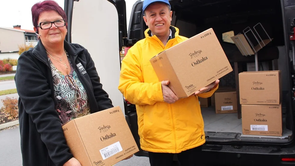 Enhetschef Karin Germundal tar tacksamt emot en rejäl leverans ostkaka från Lions Club i Vimmerby, här representerad av Simon Sauma. Ostkakan kommer att förgylla fikastunder på äldreboenden i hela kommunen. Foto: Rebecca Forsgren Malmström