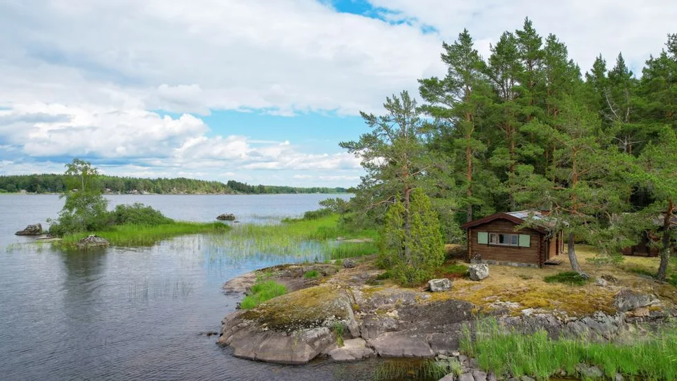 Den timrade stugan kommer med gäststuga, båt och förråd - men saknar el och vatten. 