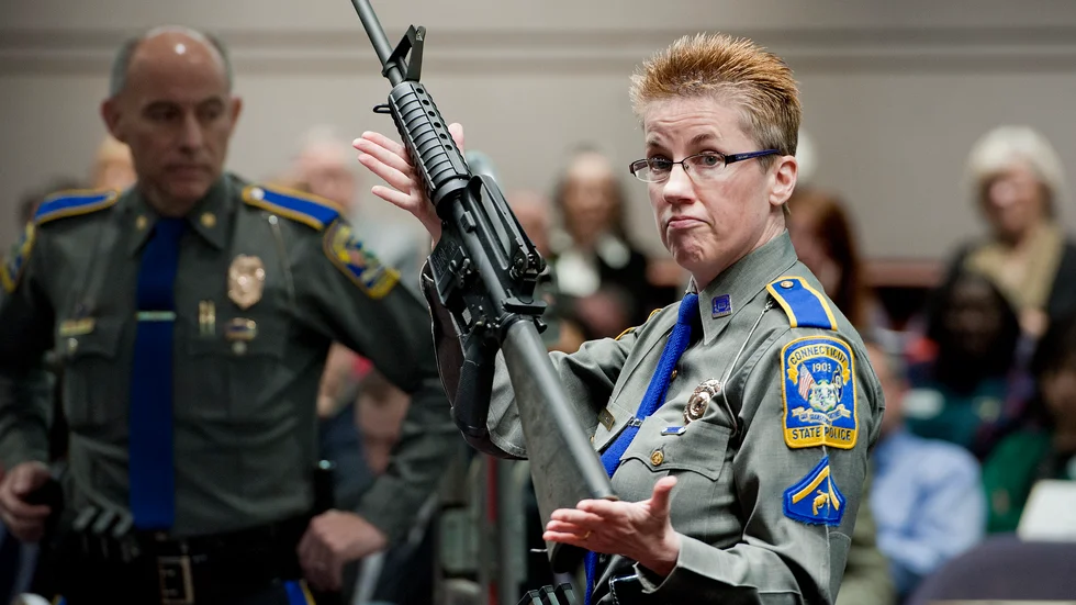 Efter massakern på Sandy Hook-skolan antog den amerikanska delstaten Connecticut striktare vapenlagar. På bilden håller en polis upp en AR-15 under en utfrågning i delstatsparlamentet 2013.