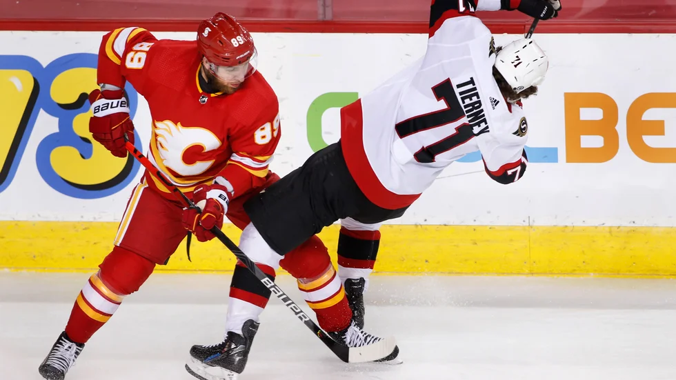 Calgarys Nikita Nesterov går på knock mot Ottawas Chris Tierney.