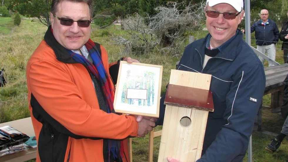 Torkel Atterbom, till vänster, är årets Västra Hargare och fick motta diplom av byalagets ordförande Staffan Nordlund samt signera en fågelholk till naturreservatet.