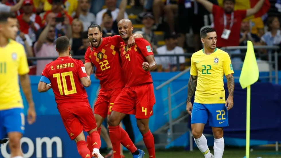 Belgium's Eden Hazard, Nacer Chadli and Vincent Kompany, from left, celebrate their first goal after Brazil's Fernandinho scored an own goal during the quarterfinal match between Brazil and Belgium at the 2018 soccer World Cup in the Kazan Arena, in Kazan, Russia, Friday, July 6, 2018. (AP Photo/Francisco Seco)