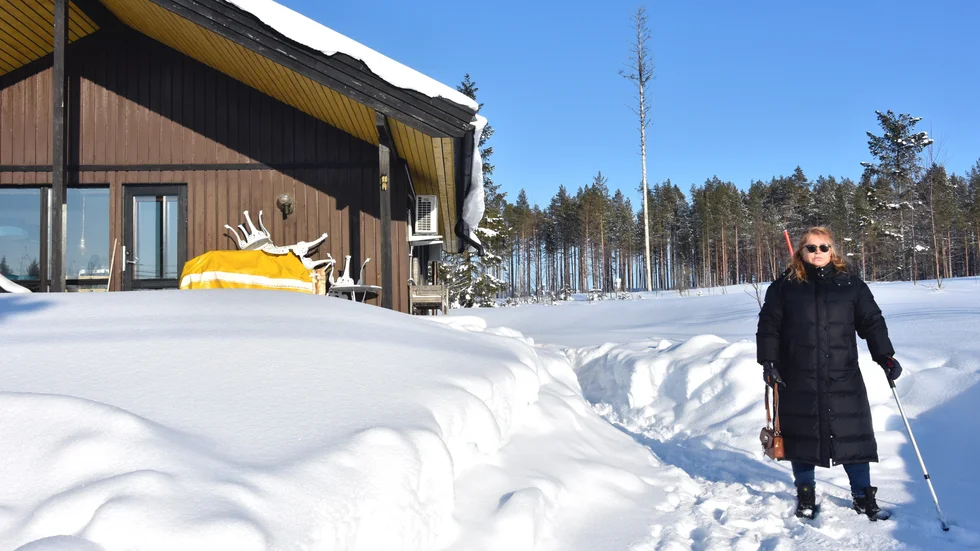 Agneta Andersson utanför stugan. Bakom henne fanns tidigare stora träd.