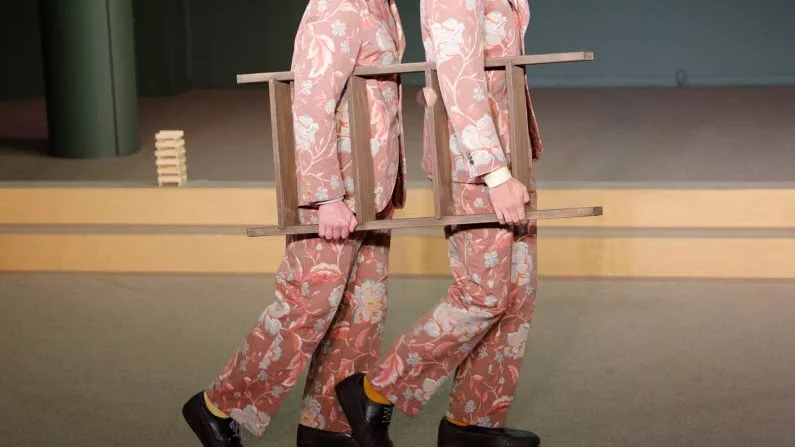 Harry Friedländer och Emil Brulin i rollerna som C:son och Johan hjälps åt att hantera ett bajskorvsproblem i "Fniss – världens tråkigaste pjäs".