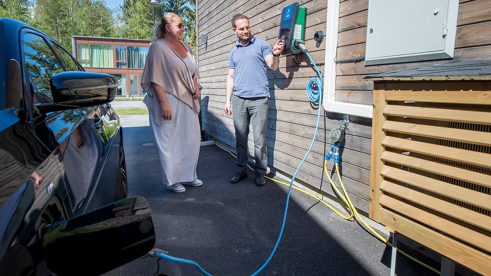 Tina Olsson Sirén och Omid Persven vid den nyinstallerade laddboxen.